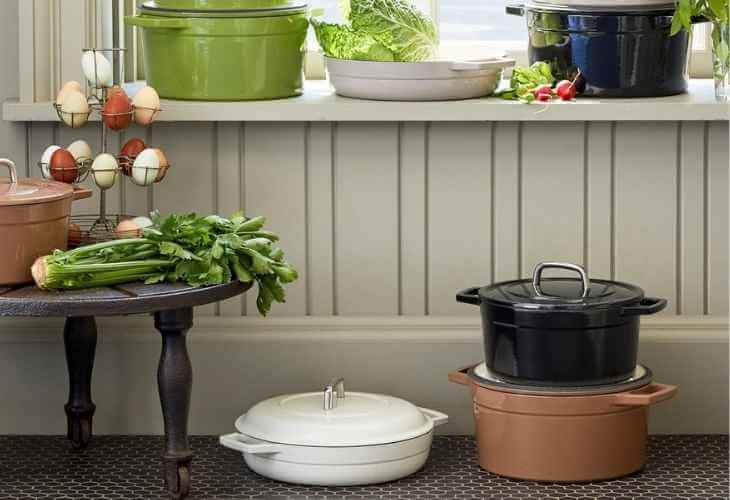 A table topped with pots and pans next to a window