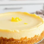 A creamy keto cheesecake with golden almond‑flour crust, topped with lemon zest on a kitchen countertop