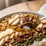 Thick pumpkin pie smoothie bowl in a shallow bowl, spoonful