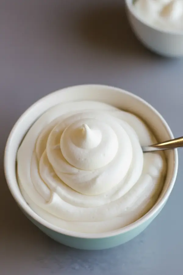 Fluffy white marshmallow frosting in a bowl