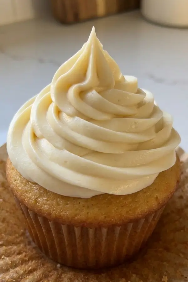Cream cheese frosting on a cupcake, close shot