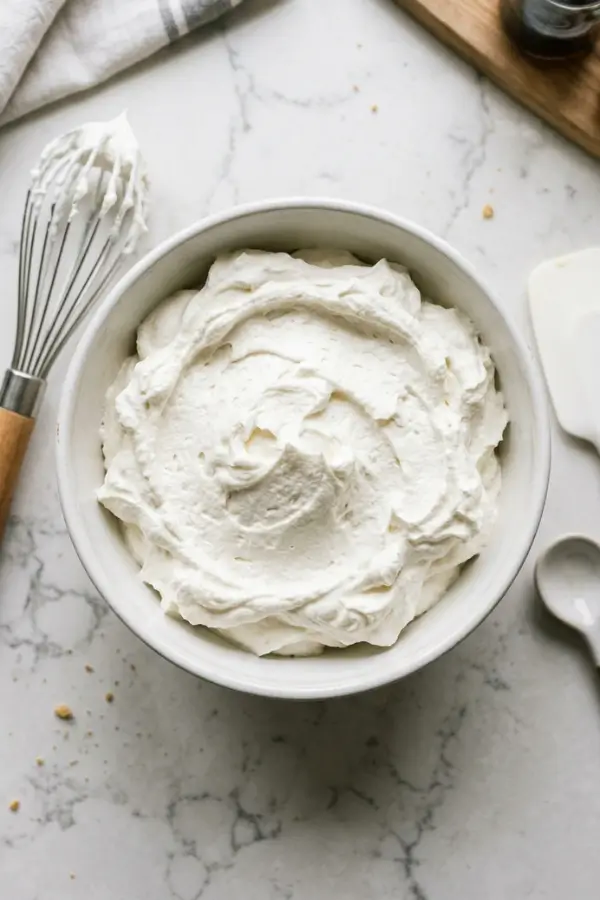 Light and fluffy whipped cream frosting in a bowl