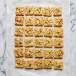 Sourdough Discard Rosemary Parmesan Crackers with Olive Oil on parchment