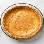 A whole Southern buttermilk pie in a glass pie dish