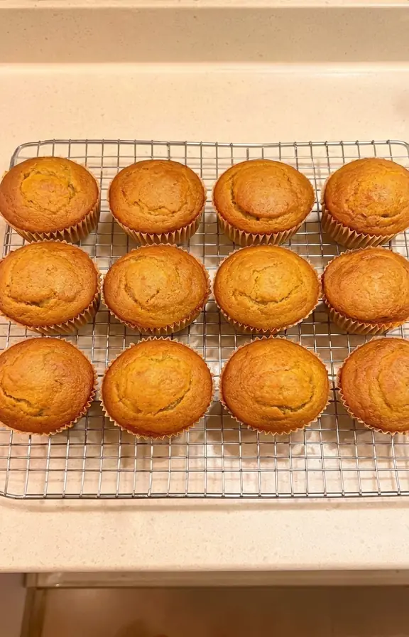 Domed gluten free pumpkin muffins cooling on a wire rack