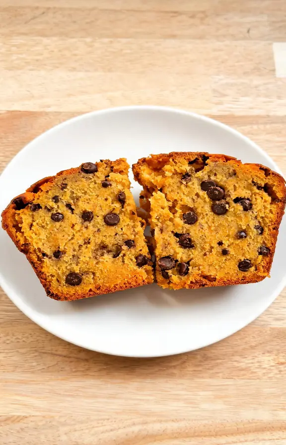 Instant-read thermometer inserted into the center of a baked pumpkin chocolate chip loaf showing the internal temperature